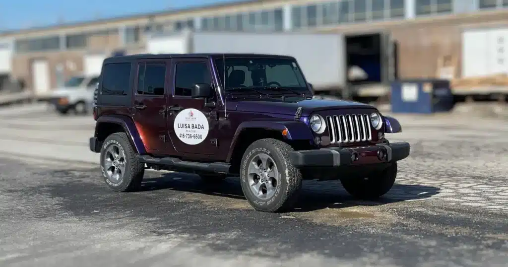 Realtor decals shown on the passenger side of the Jeep Wrangler. The photo is taken outside to get a better view of the details on the realtor decals.