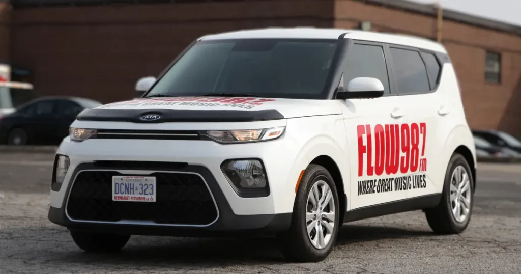 Three-quarter view of a KIA Soul displayed with decals.