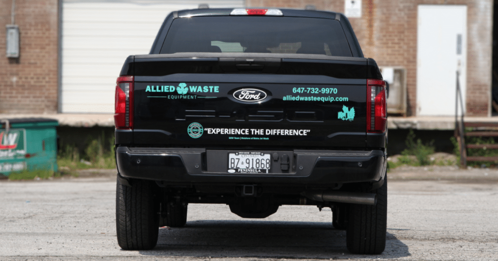 Rear view of a Ford F-150 presented with Allied Waste Equipment decals