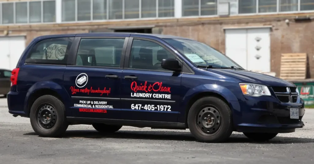 side view of a Dodge Caravan Navy showcased with vehicle decals