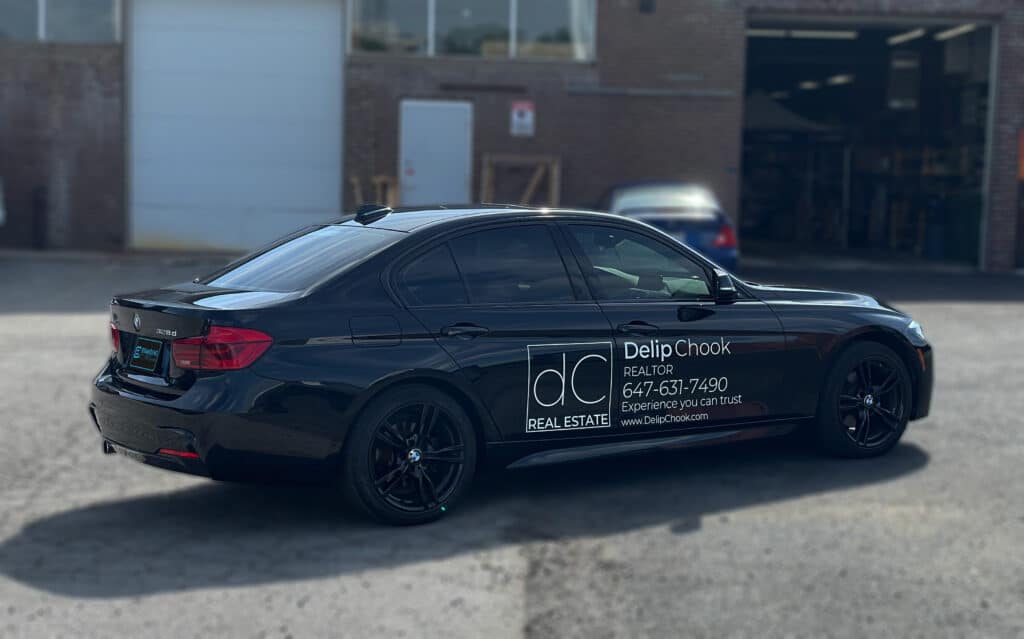 Side view of BMW 328d with custom lettering and decals installed by Branding Centres