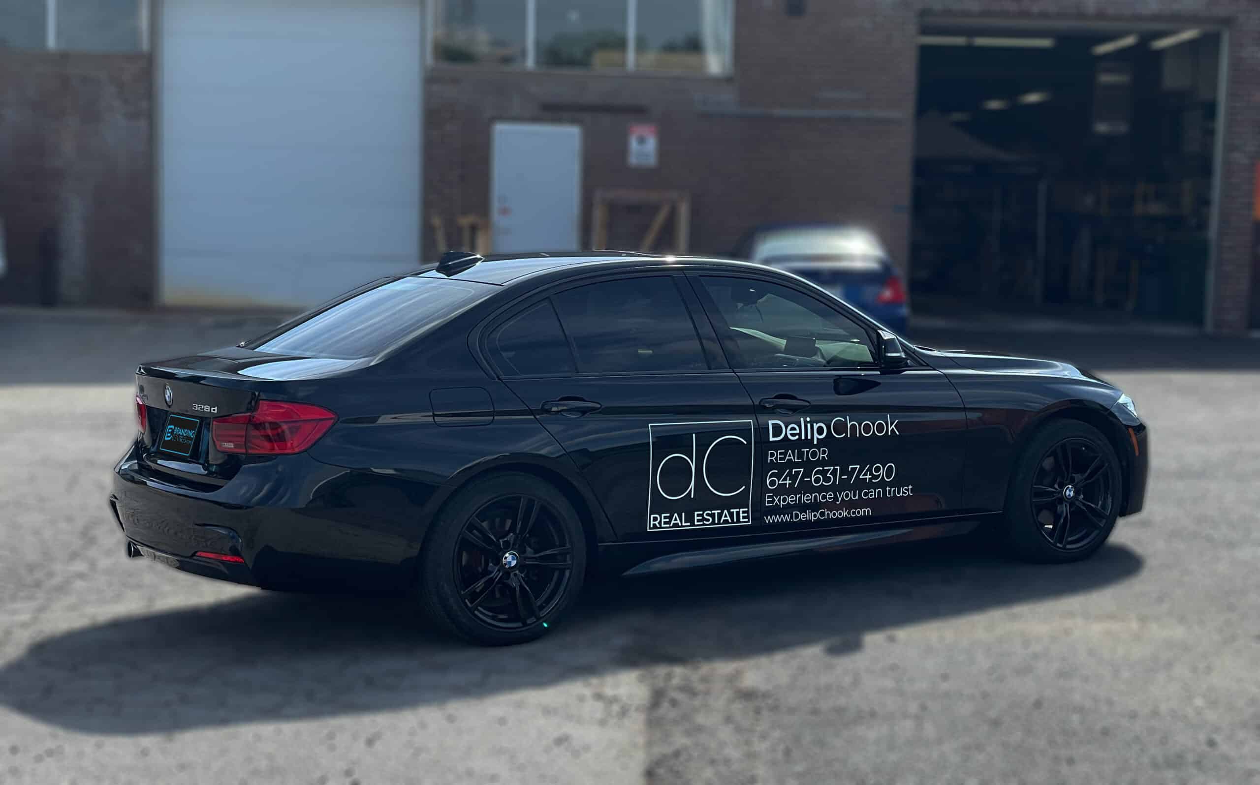 Side view of BMW 328d with custom lettering and decals installed by Branding Centres