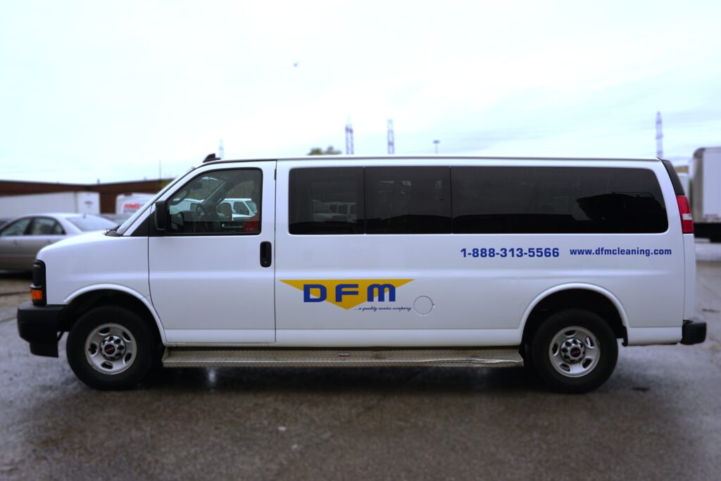 Side view of GMC Savana lettering and decals installed by Branding Centres